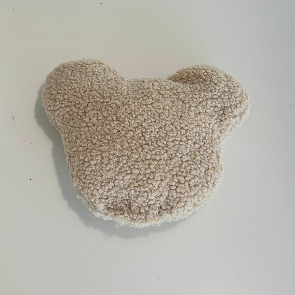 Rückansicht des POUFET Knister-Teddys aus beigem Bouclé – weiche, lockig gekräuselte Stoffstruktur